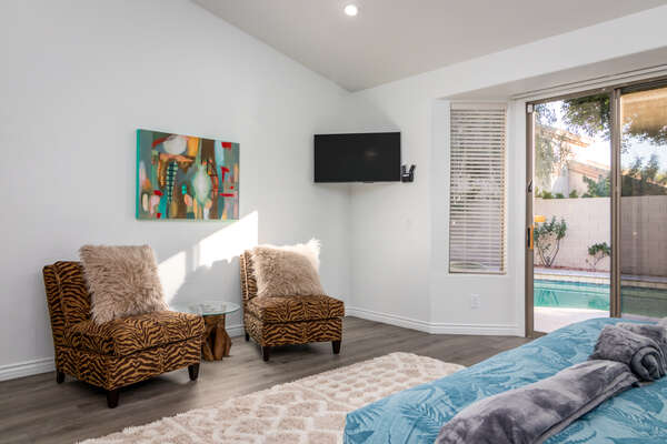 Master Bedroom with a Smart TV and Backyard Access