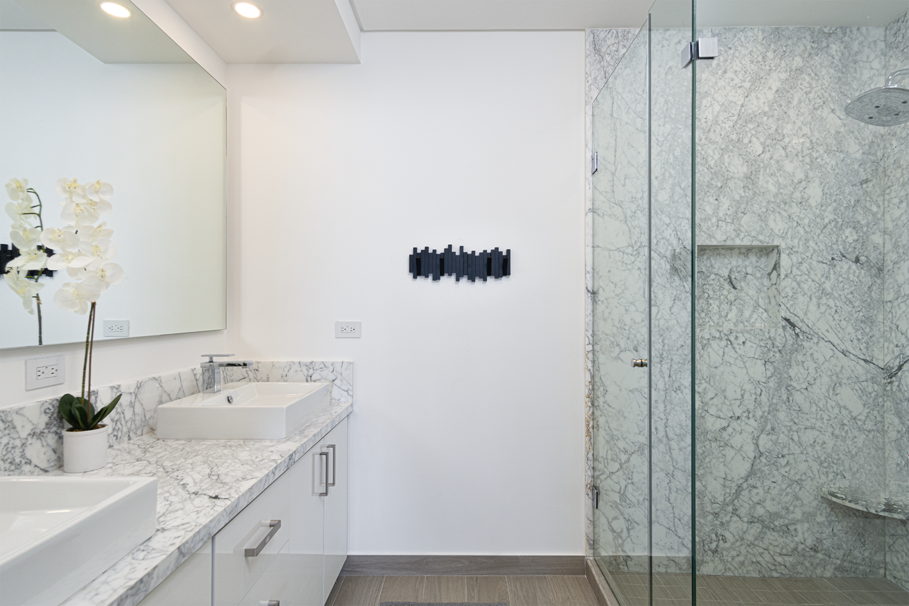 Details of the main bathroom include marbled countertop and shower stall.