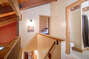 The hall on the top level overlooks the main living space on the main level.