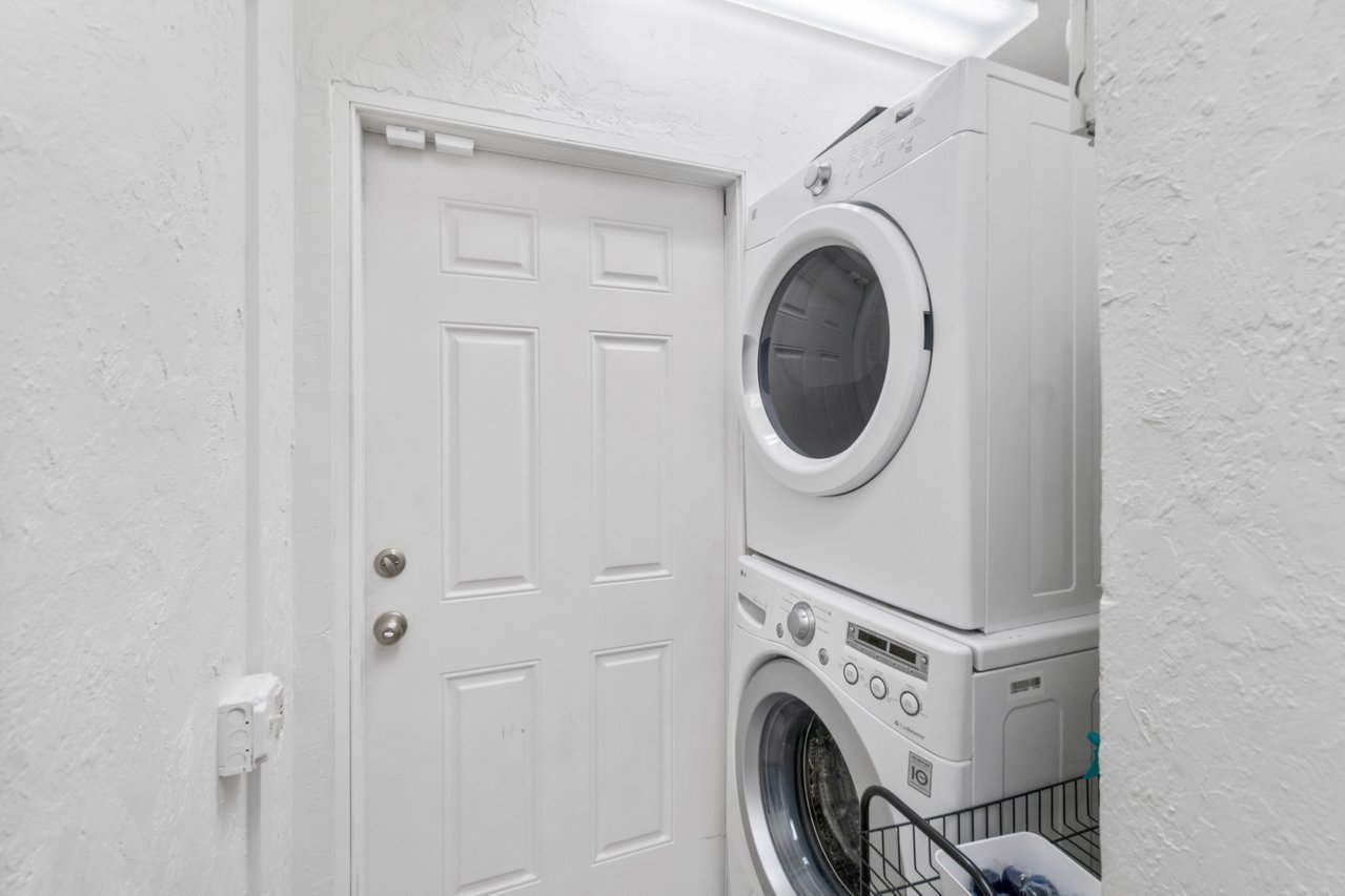 The full laundry room is also located near the living area and kitchen, and features both a washer and a dryer