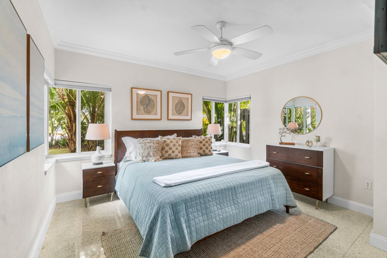 The second bedroom also features a king-sized bed, a Smart TV, and corner windows that perfectly display the full-circle landscaping of Sugar Key!
