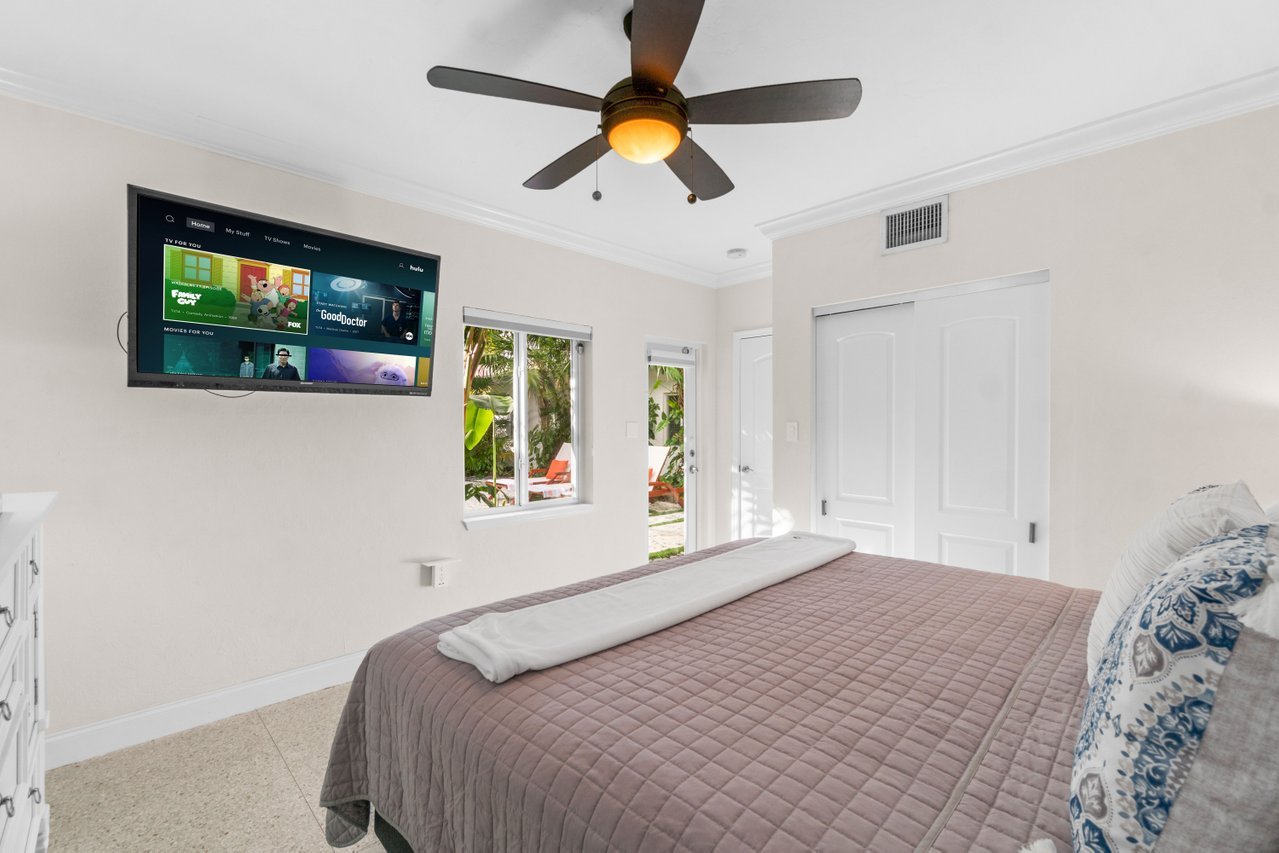 The master bedroom has direct access to the heated pool outside