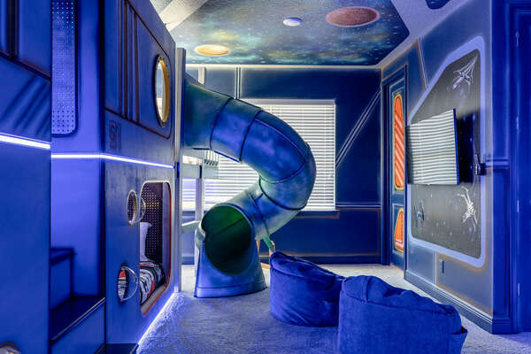 This bedroom features multiple slides for kids to enjoy