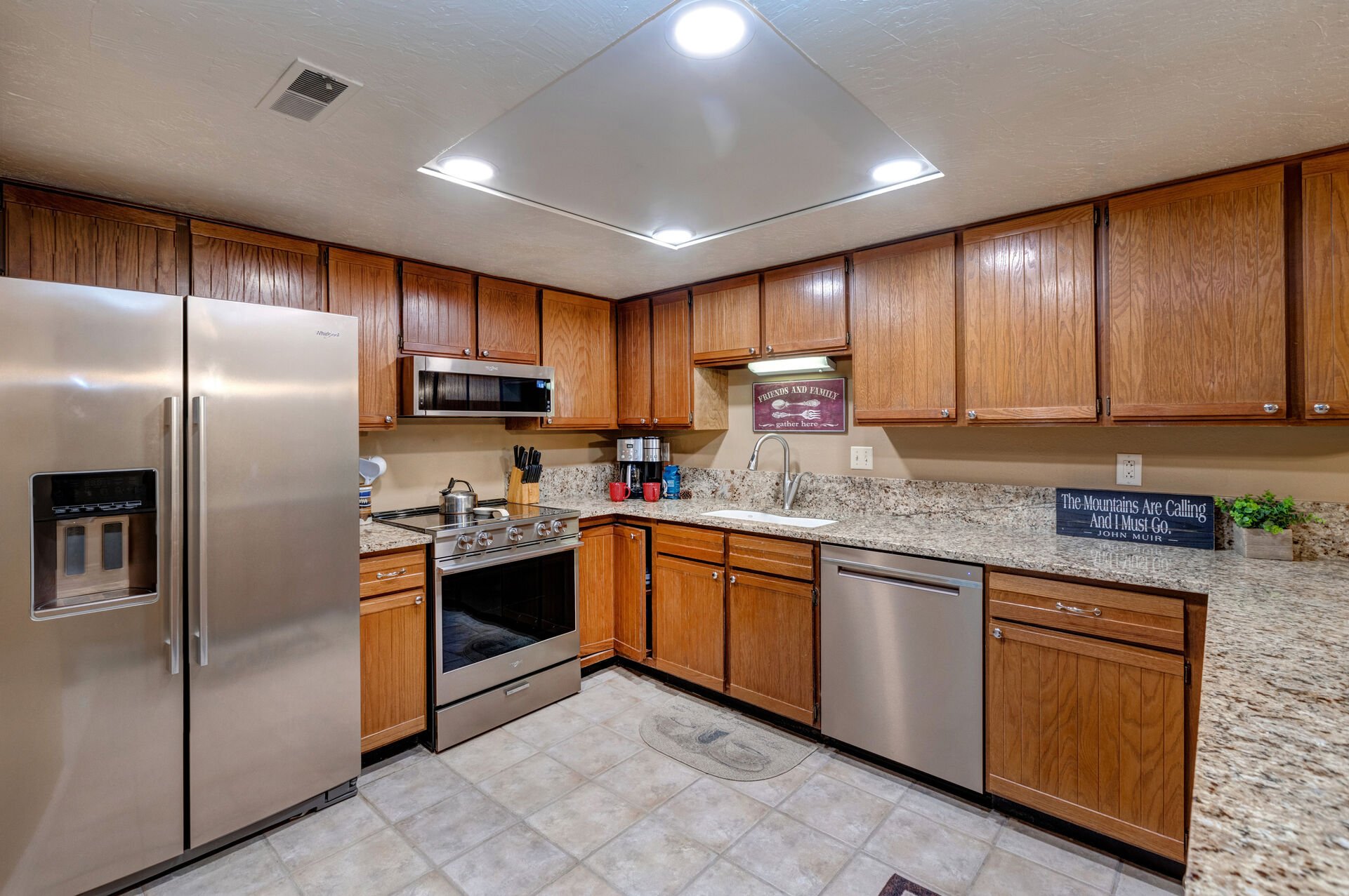 Fully Equipped Kitchen with beautiful stone countertops, stainless steel appliances, ice maker, and ample counter space for meal prep