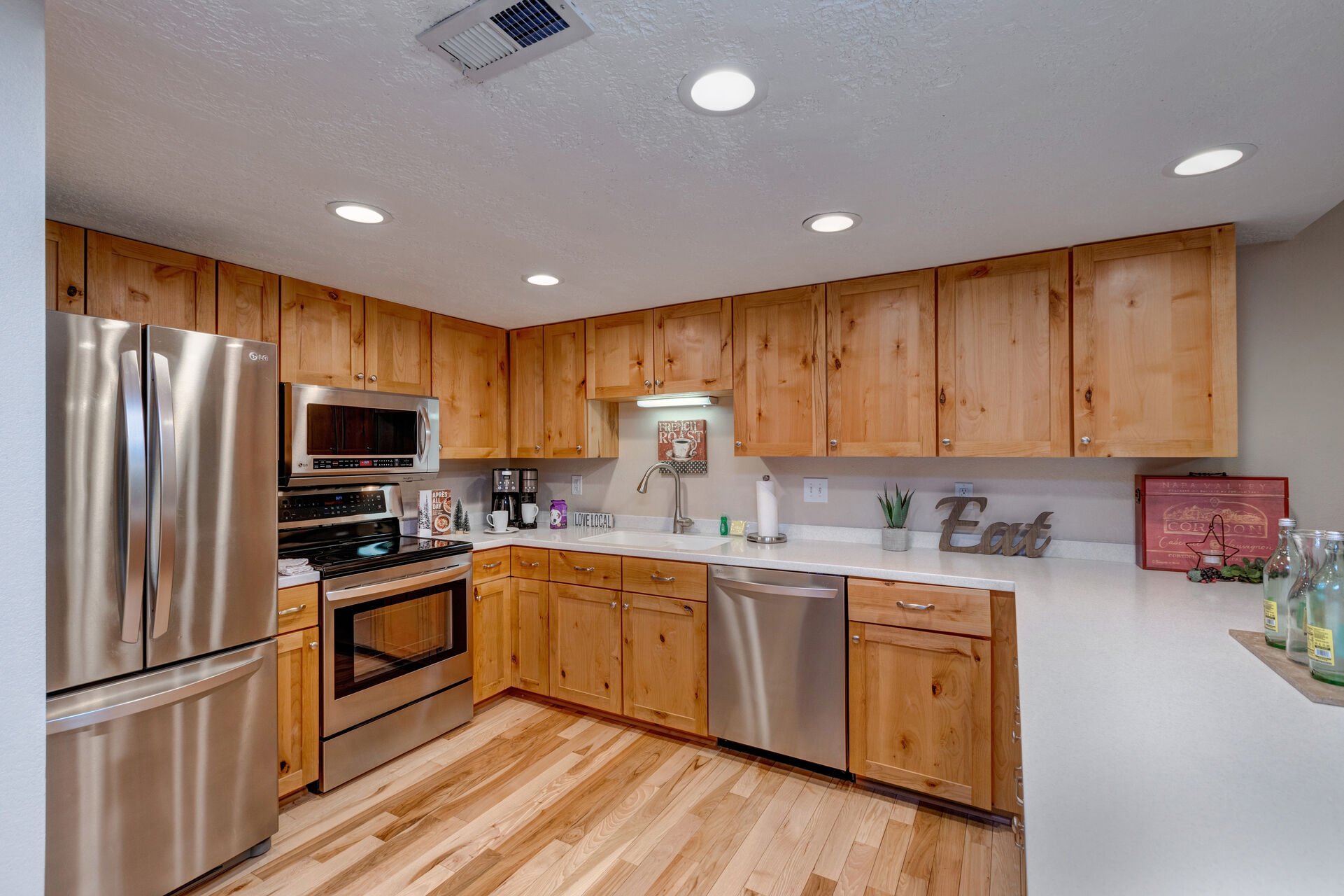 Fully Equipped Kitchen with beautiful stone countertops, stainless steel appliances, and ample counter space for meal prep