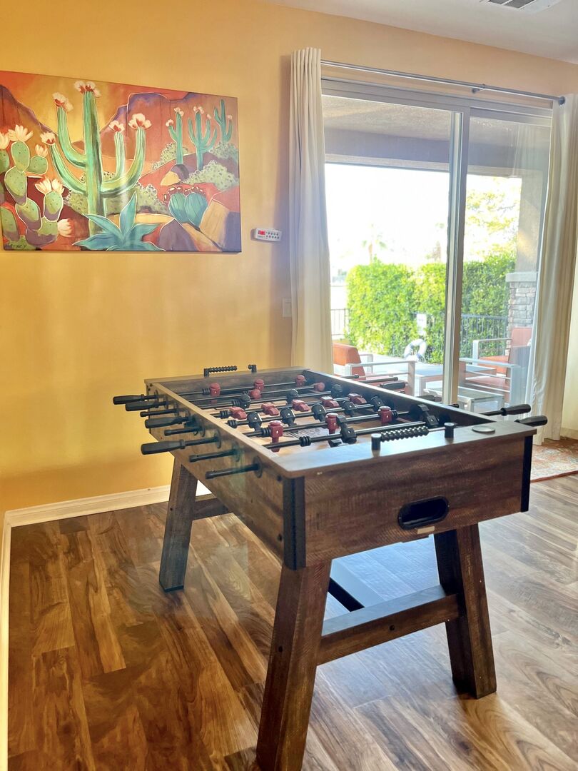 Foosball table, conveniently located by pool control and patio door, will bring you more fun!