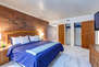 Master Bedroom with king bed, Panasonic tv, and en suite bathroom