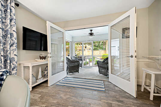 French doors lead to a screened-in porch