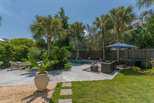 Pool area and landscaped backyard