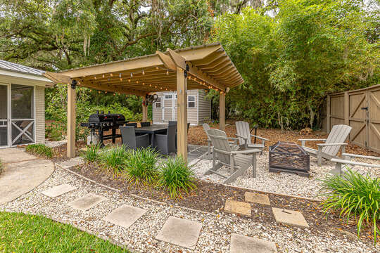 Backyard covered pergola dining and grilling area