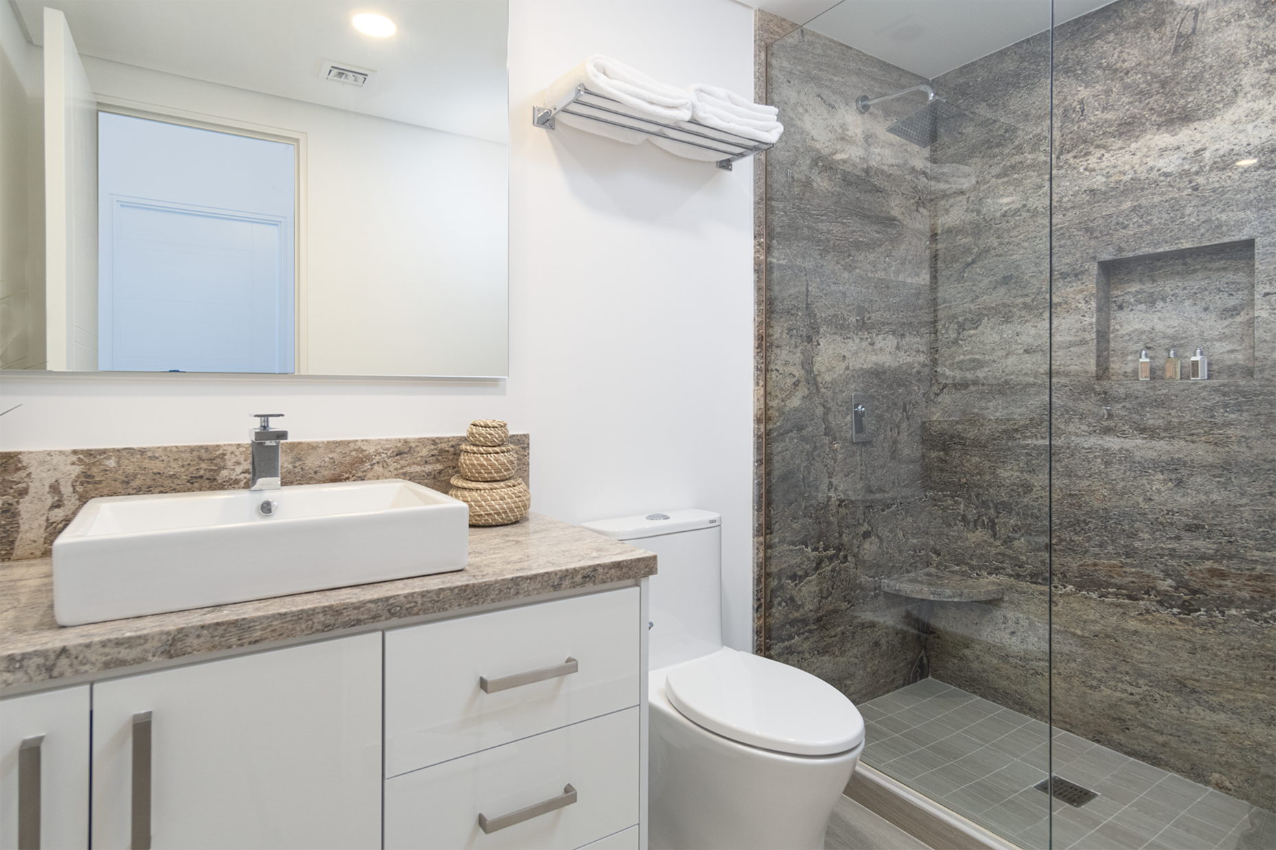 The guest bathroom with glass shower stall