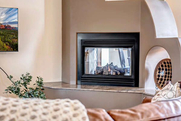 Cozy Living Room with a See-Through Gas Fireplace