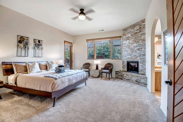 Master Bedroom with a King Bed, Gas Fireplace and Patio Access