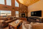 The living area has fantastic views and a cozy wood burning fireplace.