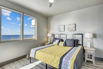 Primary (King) bedroom with access to the balcony and beautiful windows looking out on the Gulf. Mounted TV, closet and private bathroom