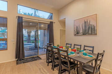 The doors in the dining area permit access to the backyard and pool.
