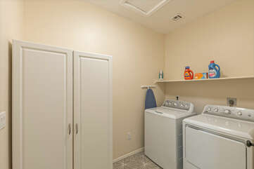 A fully stocked laundry room with family size appliances and detergent helps you conquer laundry tasks.