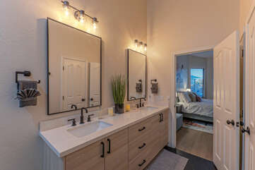 An en suite bath with dual sinks and mirrors is an appealing feature of the primary bedroom.