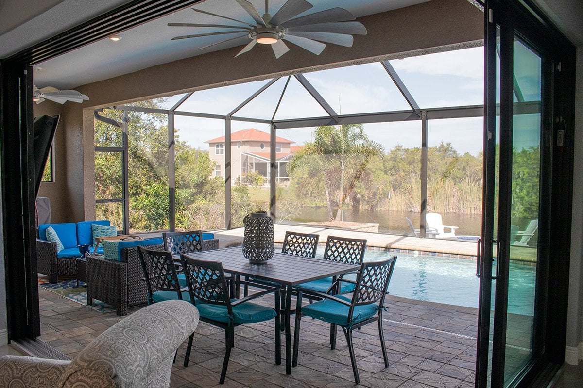 Dine al fresco on the covered and screened in lanai by the pool overlooking the canal