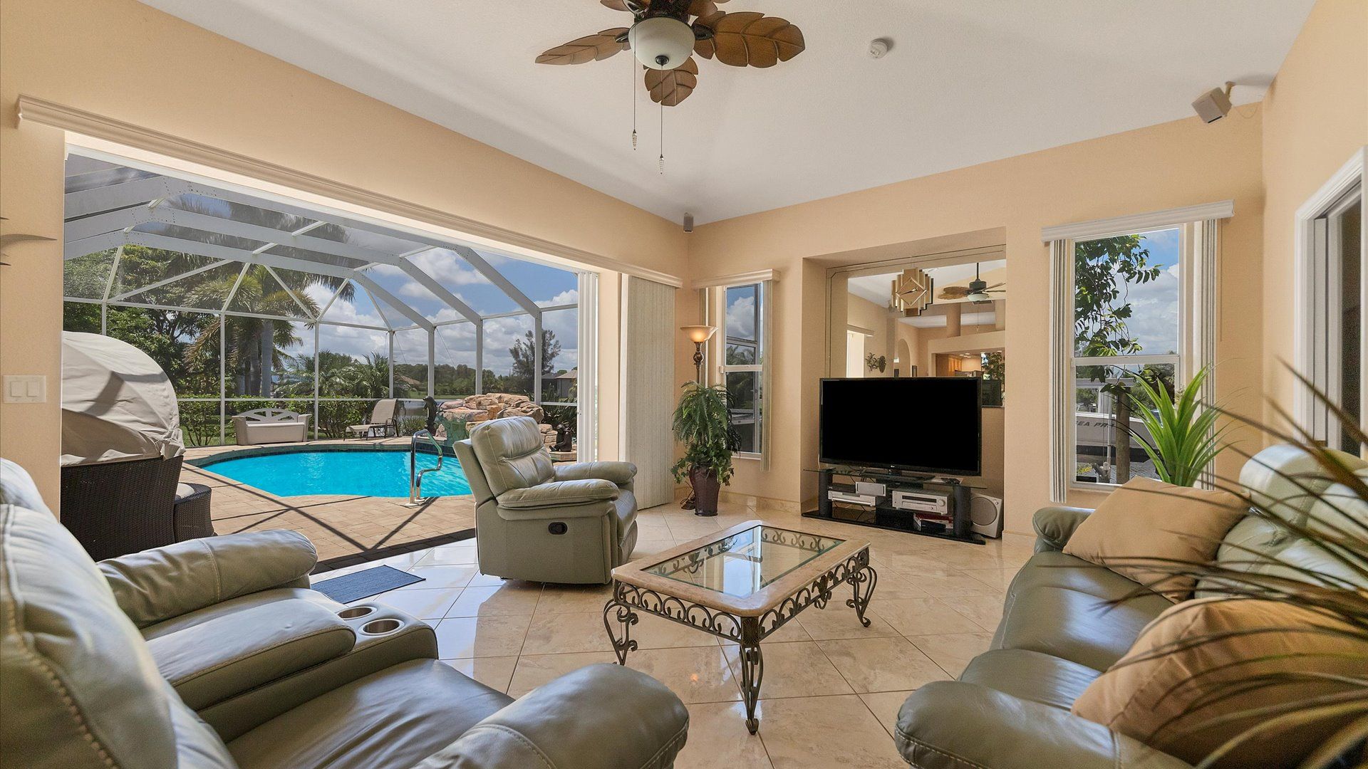 Relax on the comfortable couches in the living room, overlooking the pool and canal
