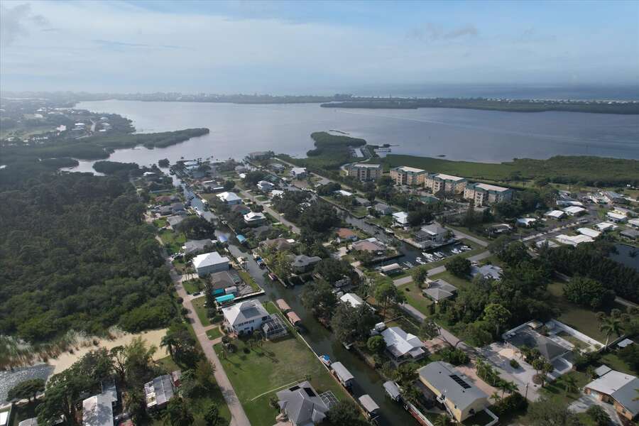 Aerial view of house and Lemon Bay with the Gulf of Mexico just beyond