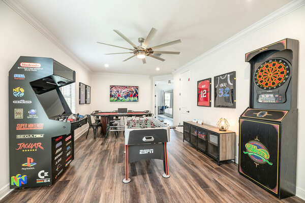 The entertainment loft features a dartboard, a foosball table, a multi-game arcade, and a professional poker table