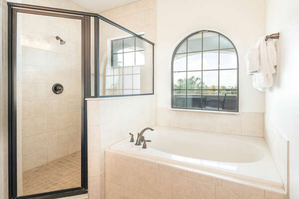 The master suite bathroom features a garden tub and separate walk-in shower