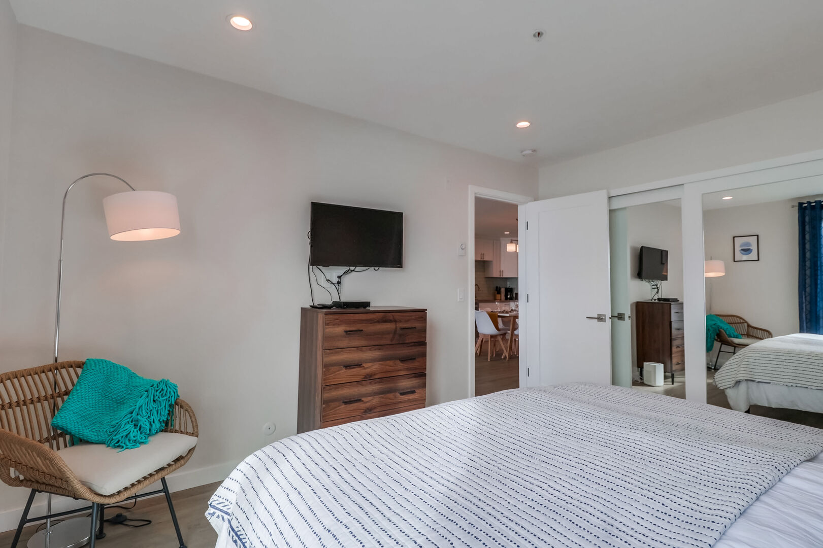 Master bedroom with king-size bed, smart TV, dresser storage and large closets. (In the closets are 2 stand-up fans, hangers, 2 laundry hampers and a portable a/c unit) Please note: the portable a/c unit can be reserved with a $25/day plus tax usage fee)