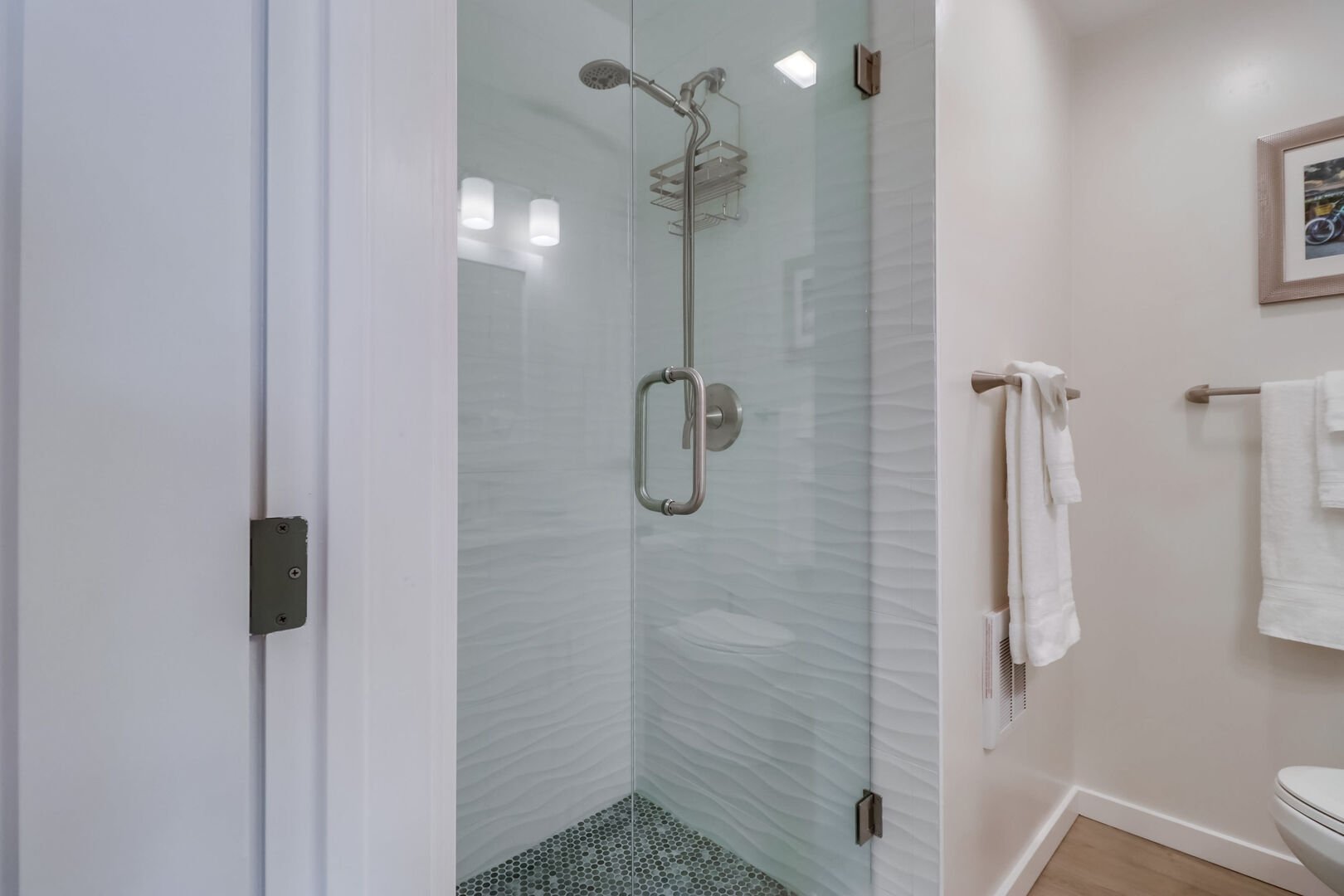 Guest bathroom with walk-in shower (please note: there is a step to get in) with overhead, hand-held shower head