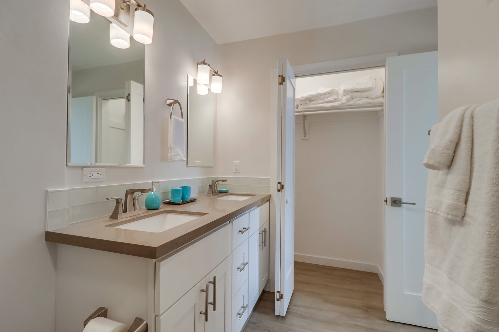 Master in-suite bathroom with dual vanity and open, large linen closet