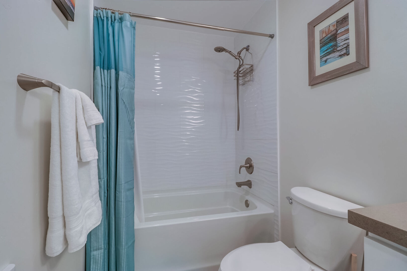 Master in-suite bathroom with tub/shower combo and overhead, hand-held shower head