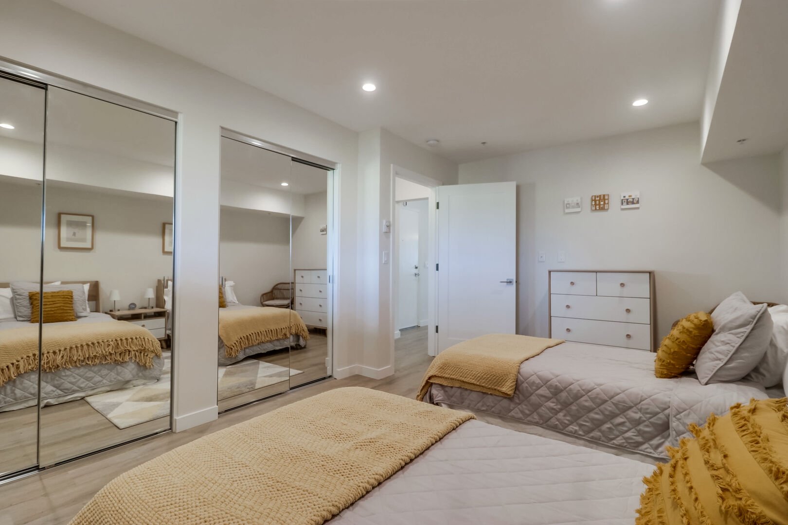 Guest bedroom with 2 twin beds and ample storage and dresser space. Large closets come with iron, ironing board, step stool, cleaning equipment (such as vacuum, mop, broom) hangers and beach accessories.