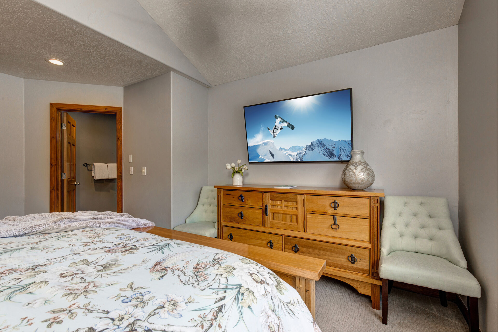 Upper Level Master Bedroom with king bed, Samsung smart tv, seating area, walk-in closet, and en suite bathroom