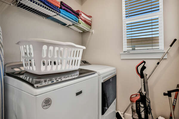 The laundry includes a full-sized washer and drying, iron and ironing board
