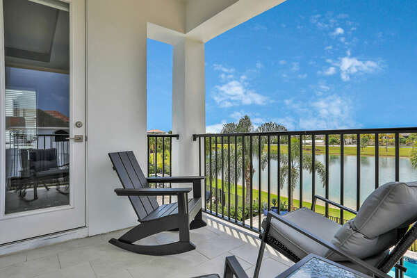 This room also features a balcony overlooking the pool and water