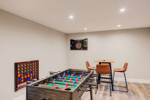 Game Room - Fitness Room.  Bank shuffle board, foosball table, digital dart board, Concept II rowing machine, 4-seat highboy table, connect 4, and 65