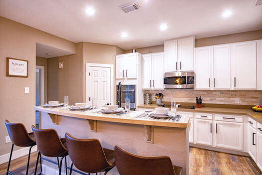 Well stocked and completely renovated gourmet display kitchen with center island and 4 bar seats