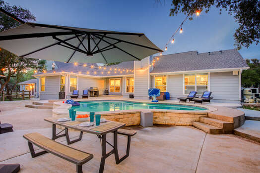 Resort-style living!  Beautiful heated pool, hot tub, putting green, multi-use sport area, and fire pit all on 2 acres of privacy in Hill Country.  Plenty of outdoor seating for the whole family.
