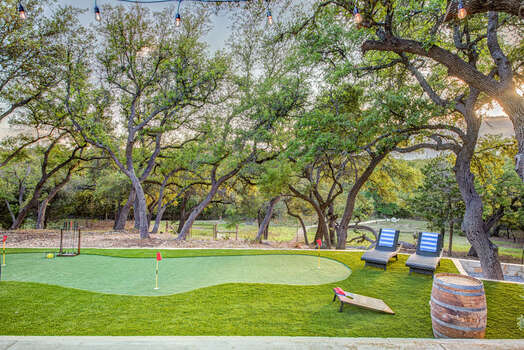 Incredible back yard with heated pool, hot tub, plenty of outdoor seating, putting green and fire pit