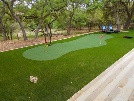 View of the putting green/multi sport area that is so much fun for kids and adults alike.   You will have so much fun in the back yard!