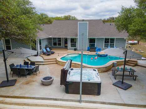 Incredible back yard with heated pool, hot tub, plenty of outdoor seating, putting green and fire pit