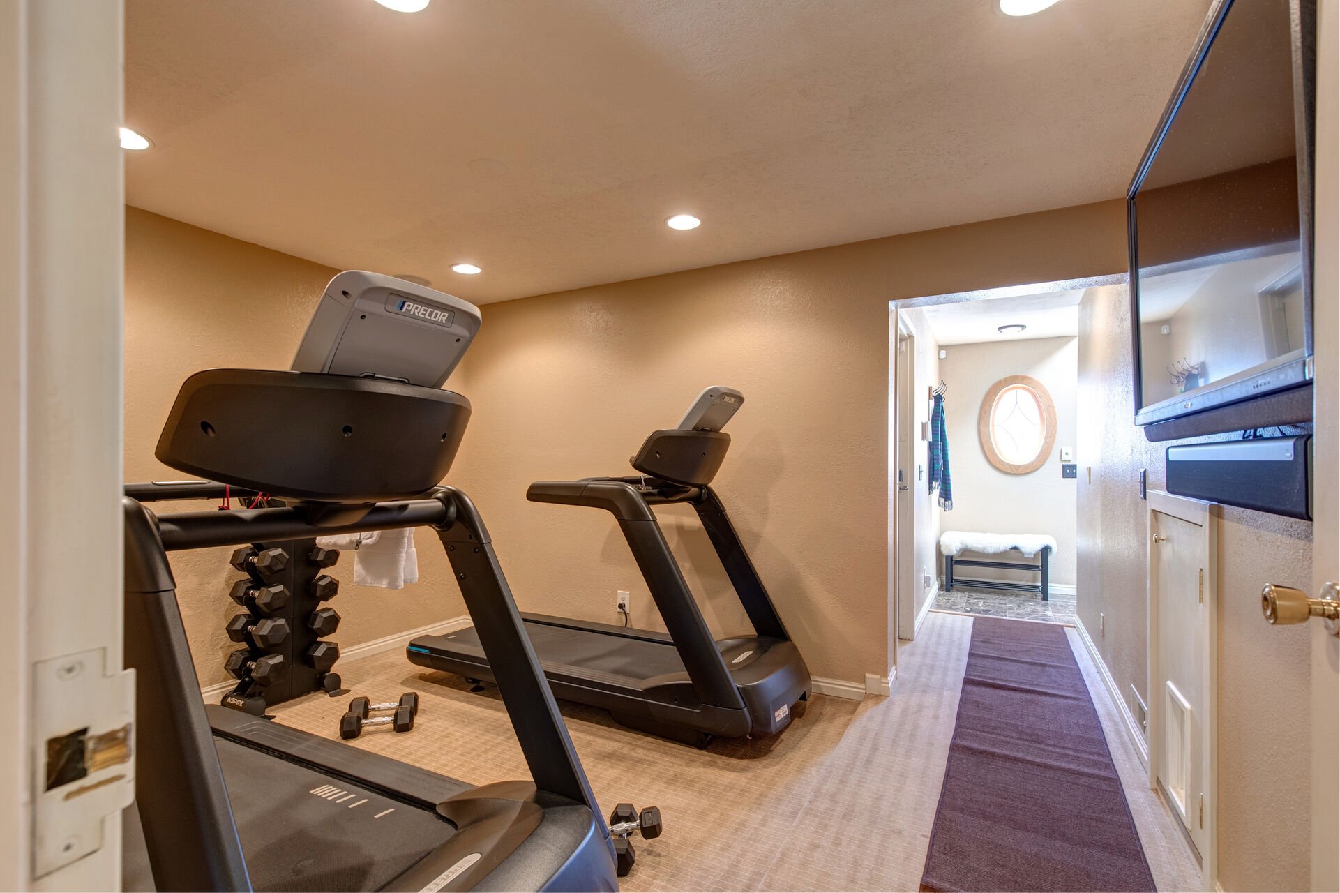 Entry/Lower Level Fitness Area with Two Treadmills, Weights and  a HD TV with Cable
