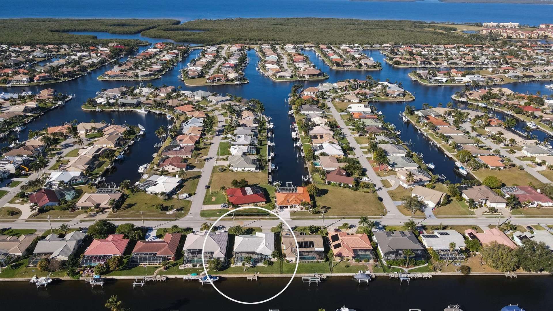 Aerial view of the house in the Punta Gorda Isles canal network and Charlotte Harbor just beyond