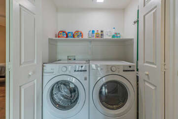 Well stocked laundry area is behind bifold doors.