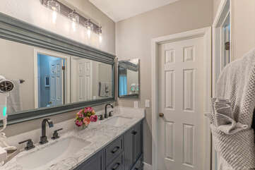 The primary suite bath is newly remodeled and has dual vanity sinks.