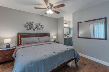 Primary suite features a king bed, TV and en suite bath with a walk-in closet.