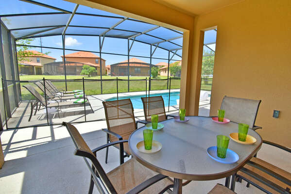 Shaded lanai area with patio table seating 6