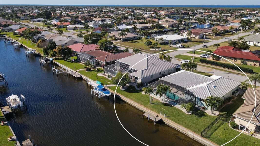 Aerial view of the house on canal and Charlotte Harbor just beyond
