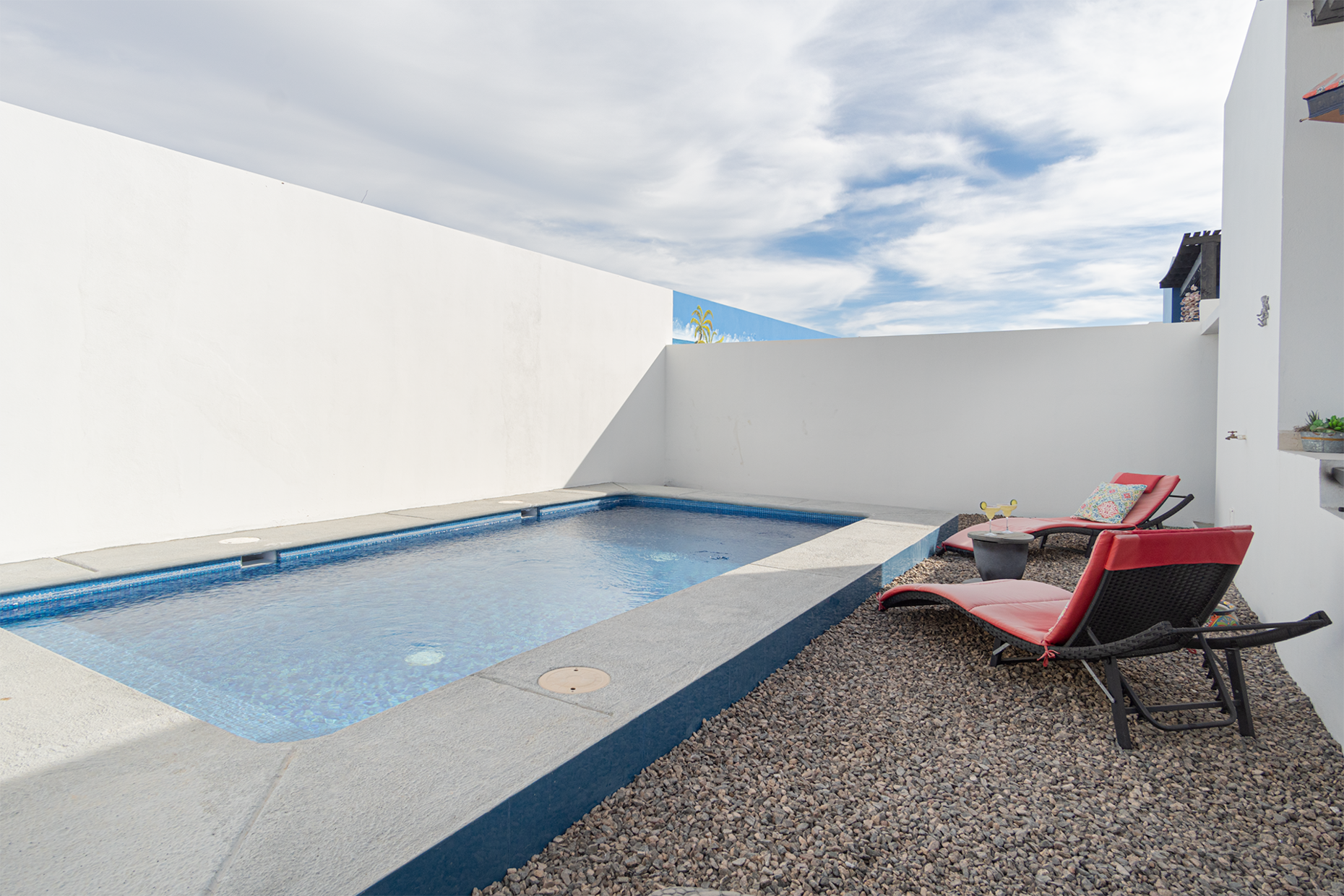 the pool and chaise lounges