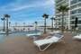 Below your unit is the large pool deck with lots of chaise loungers.